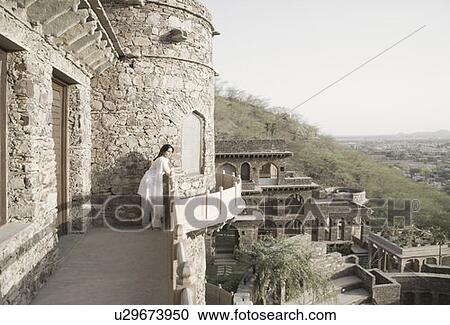 Side profile of a young woman leaning on the balcony of a fort, Neemrana Fort Palace, Neemrana, Alwar, Rajasthan, India View Large Photo Image Stock Image - Side profile of a young woman leaning on the balcony of a fort, Neemrana Fort Palace, Neemrana, Alwar, Rajasthan, India. Fotosearch