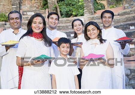 Two mid adult couples and a young couple with a boy holding plates of powder paint View Large Photo Image Stock Image - Two mid adult couples and a young couple with a boy holding plates of powder paint. Fotosearch
