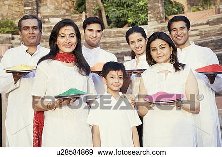 Stock Photo - Two mid adult couples and a young couple with a boy holding plates of powder paint. Fotosearch
