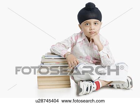 Picture - Portrait of a boy sitting with cross-legged . Fotosearch