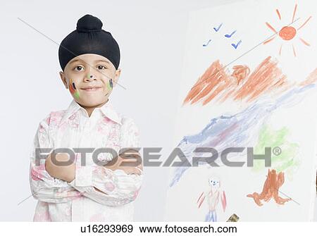 Stock Photo - Portrait of a boy standing with his arms crossed. Fotosearch