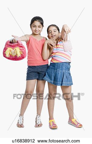 Portrait of girls showing their purse View Large Photo Image Stock Image - Portrait of girls showing their purse. Fotosearch