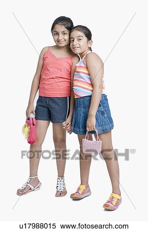 Stock Photography - Portrait of two girls standing together and smiling. Fotosearch