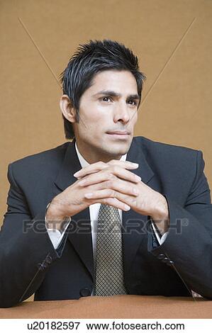 Close-up of a businessman thinking View Large Photo Image Stock Photo - Close-up of a businessman thinking. Fotosearch