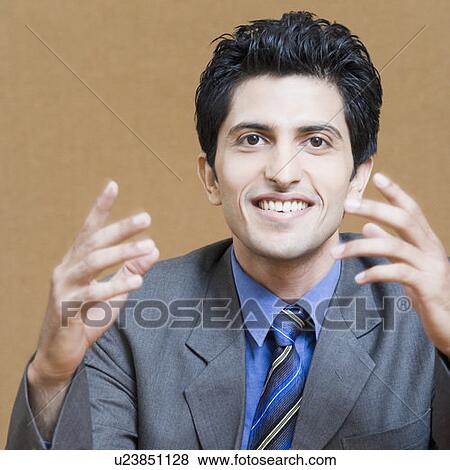 Portrait of a businessman gesturing and smiling View Large Photo Image Stock Photo - Portrait of a businessman gesturing and smiling. Fotosearch