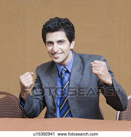 Portrait of a businessman showing his fists and smiling View Large Photo Image Stock Image - Portrait of a businessman showing his fists and smiling. Fotosearch