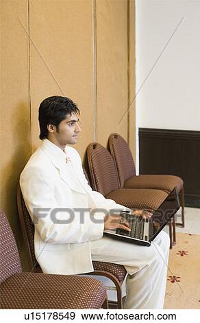 Side profile of a businessman using a laptop View Large Photo Image Stock Photo - Side profile of a businessman using a laptop. Fotosearch