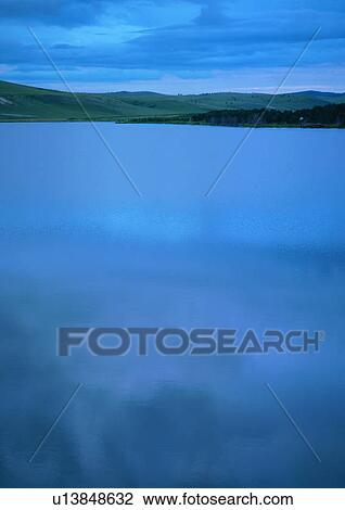 Stock Image - A view of mountains from a lake. Fotosearch