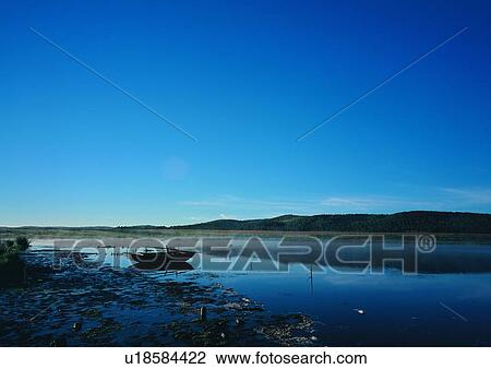 Stock Image - Light, Coast, Dawn, Boat, Travel Destinations, Dusk, Shore. Fotosearch