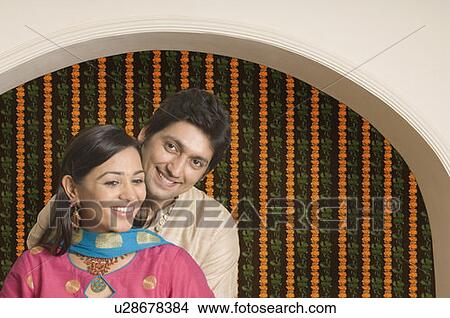 Picture - Close-up of a couple standing together and smiling. Fotosearch