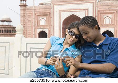 Close-up of a young couple looking at a digital camera, Taj Mahal, Agra, Uttar Pradesh, India View Large Photo Image Stock Image - Close-up of a young couple looking at a digital camera, Taj Mahal, Agra, Uttar Pradesh, India. Fotosearch