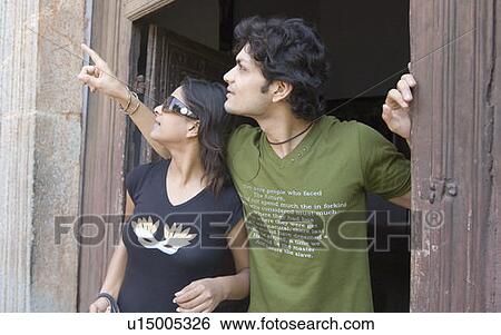 Close-up of a young couple standing at a doorway, Goa, India View Large Photo Image Stock Photograph - Close-up of a young couple standing at a doorway, Goa, India. Fotosearch