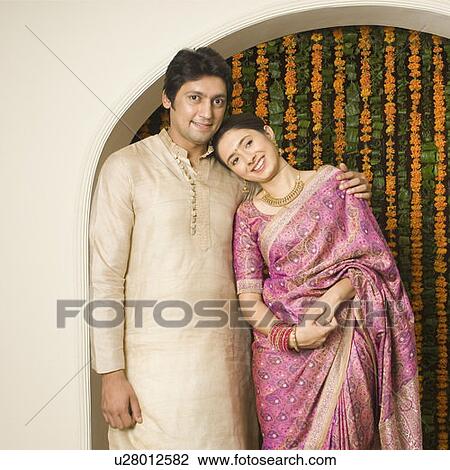Portrait of a couple standing together and smiling View Large Photo Image Stock Image - Portrait of a couple standing together and smiling. Fotosearch
