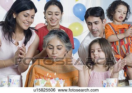 Mature woman celebrating her birthday with her friends View Large Photo Image Stock Photograph - Mature woman celebrating her birthday with her friends. Fotosearch