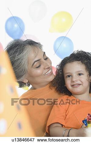 Mature woman smiling with her grandson View Large Photo Image Stock Photo - Mature woman smiling with her grandson. Fotosearch