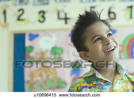 Stock Photography - Close-up of a schoolboy smiling and looking up. Fotosearch