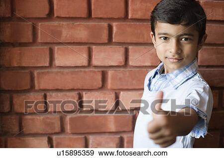 Portrait of a boy making a thumbs up sign View Large Photo Image Stock Photo - Portrait of a boy making a thumbs up sign. Fotosearch