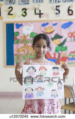 Portrait of a girl showing a drawing and smiling View Large Photo Image Stock Photography - Portrait of a girl showing a drawing and smiling. Fotosearch