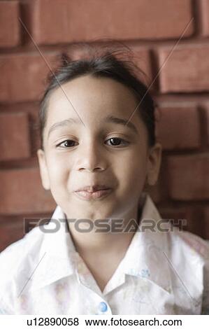 Portrait of a girl smirking View Large Photo Image Stock Photo - Portrait of a girl smirking. Fotosearch