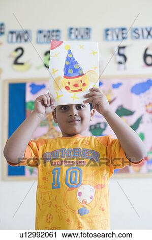 Portrait of a schoolboy showing a painting View Large Photo Image Stock Image - Portrait of a schoolboy showing a painting. Fotosearch