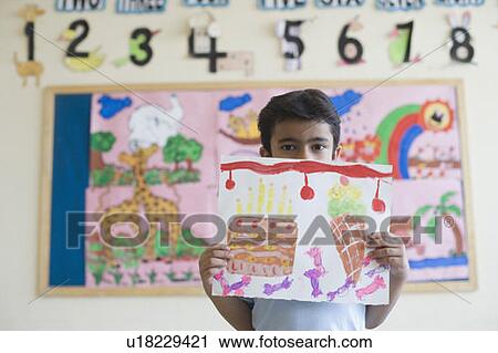 Portrait of a schoolboy showing a painting View Large Photo Image Stock Image - Portrait of a schoolboy showing a painting. Fotosearch