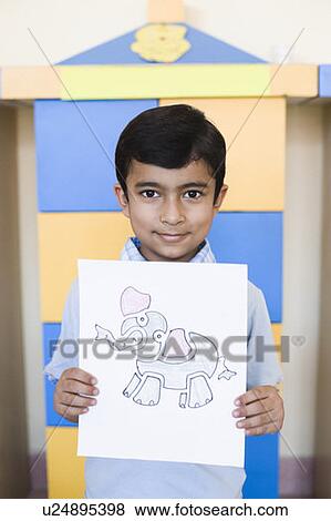 Stock Photo - Portrait of a schoolboy showing a drawing. Fotosearch