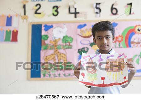 Portrait of a schoolboy showing a drawing View Large Photo Image Stock Photo - Portrait of a schoolboy showing a drawing. Fotosearch
