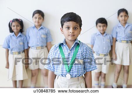 Portrait of a schoolboy with a medal around his neck with his classmates in the background View Large Photo Image Stock Photography - Portrait of a schoolboy with a medal around his neck with his classmates in the background. Fotosearch