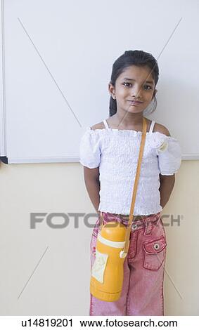 Portrait of a schoolgirl leaning against a wall in a classroom View Large Photo Image Stock Image - Portrait of a schoolgirl leaning against a wall in a classroom. Fotosearch
