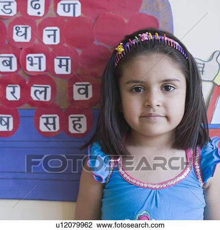 Portrait of a schoolgirl standing in front of a chart View Large Photo Image Stock Image - Portrait of a schoolgirl standing in front of a chart. Fotosearch