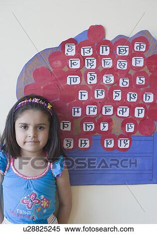 Stock Photography - Portrait of a schoolgirl standing in front of a chart. Fotosearch