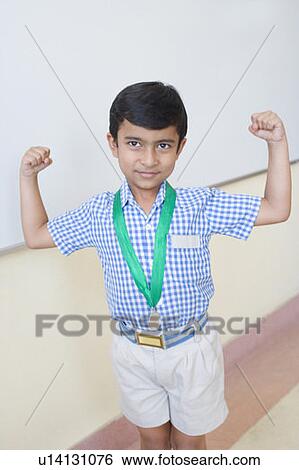 School boy with a medal around his neck and flexing muscles View Large Photo Image Stock Photograph - School boy with a medal around his neck and flexing muscles. Fotosearch