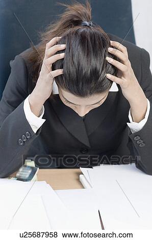 Businesswoman sitting with her head in her hands View Large Photo Image Stock Photo - Businesswoman sitting with her head in her hands. Fotosearch