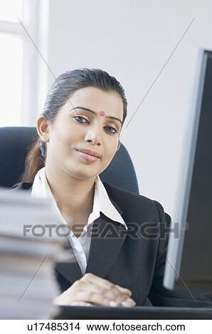 Close-up of a businesswoman working on a computer View Large Photo Image Picture - Close-up of a businesswoman working on a computer. Fotosearch