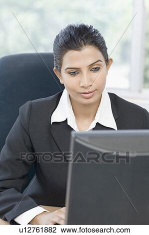 Close-up of a businesswoman working on a computer View Large Photo Image Stock Image - Close-up of a businesswoman working on a computer. Fotosearch
