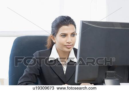 Close-up of a businesswoman working on a computer View Large Photo Image Stock Image - Close-up of a businesswoman working on a computer. Fotosearch