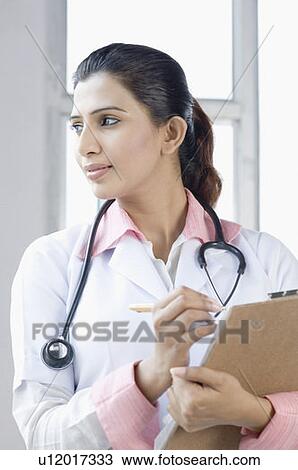 Close-up of a female doctor standing with a stethoscope around her neck View Large Photo Image Stock Image - Close-up of a female doctor standing with a stethoscope around her neck. Fotosearch