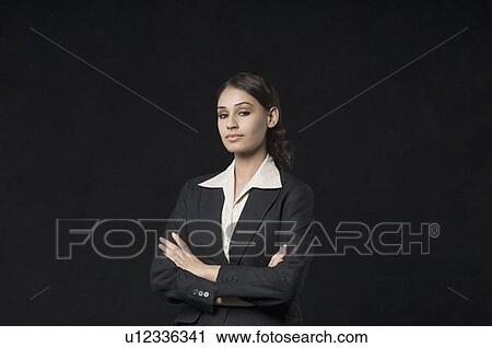Stock Image - Portrait of a businesswoman with her arms crossed. Fotosearch