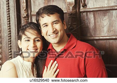 Close-up of a mid adult couple embracing each other and smiling View Large Photo Image Stock Image - Close-up of a mid adult couple embracing each other and smiling. Fotosearch