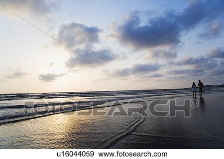 Couple standing on the beach View Large Photo Image Stock Photo - Couple standing on the beach. Fotosearch