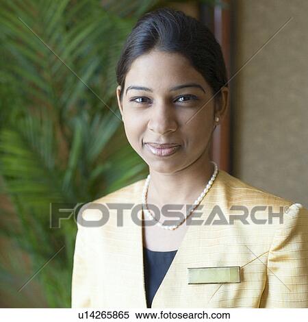 Stock Photography - Portrait of a waitress smirking. Fotosearch