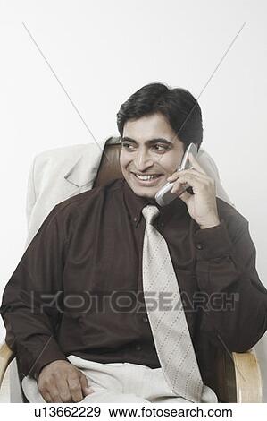 Stock Photo - Close-up of a businessman talking on a mobile phone. Fotosearch