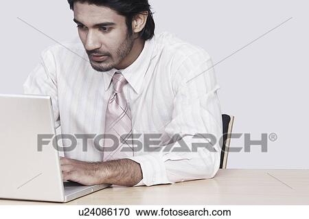 Close-up of a businessman using a laptop View Large Photo Image Stock Image - Close-up of a businessman using a laptop. Fotosearch