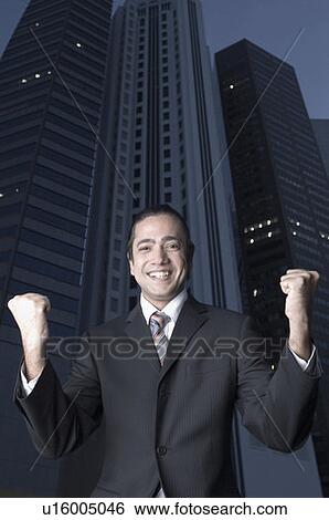 Portrait of a businessman clenching his fist and smiling, Singapore View Large Photo Image Stock Photograph - Portrait of a businessman clenching his fist and smiling, Singapore. Fotosearch
