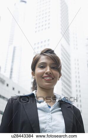 Picture - Portrait of a businesswoman smiling, Singapore. Fotosearch