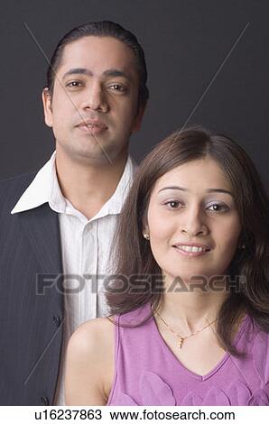 Portrait of a couple standing together and smiling View Large Photo Image Stock Image - Portrait of a couple standing together and smiling. Fotosearch
