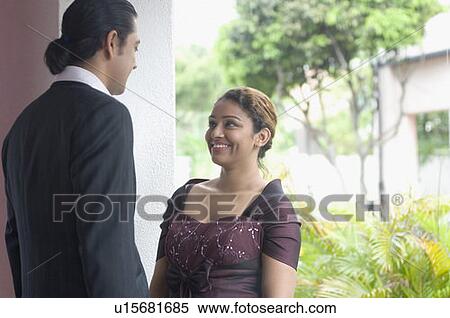 Side profile of a couple standing together and looking at each other View Large Photo Image Stock Photography - Side profile of a couple standing together and looking at each other. Fotosearch