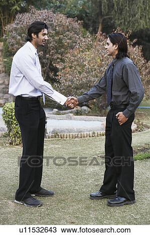 Side profile of two businessmen shaking hands View Large Photo Image Stock Image - Side profile of two businessmen shaking hands. Fotosearch
