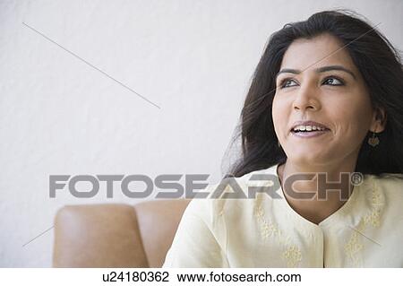 Close-up of a young woman smiling View Large Photo Image Stock Image - Close-up of a young woman smiling. Fotosearch