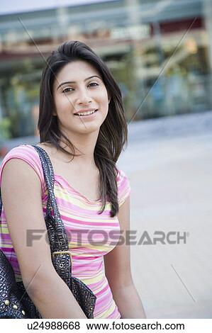 Portrait of a young woman smiling View Large Photo Image Stock Photo - Portrait of a young woman smiling. Fotosearch